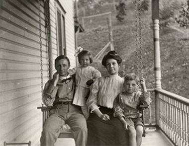 Old picture of family on porch swing 