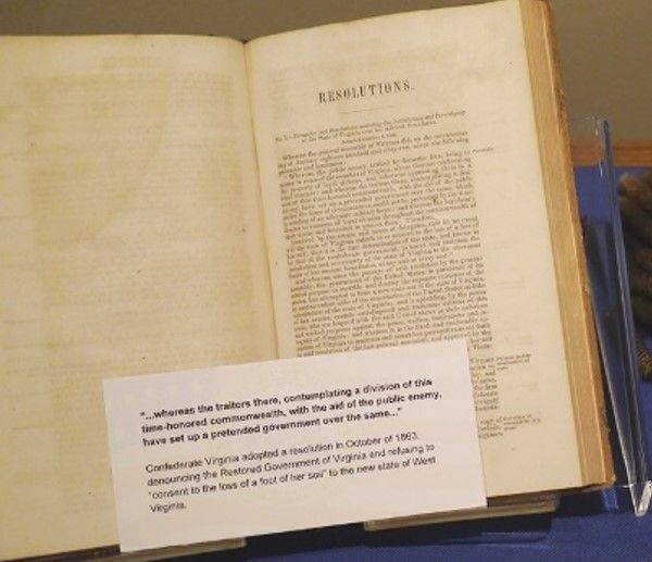 A book displayed with a card in front discussing the Confederacy's reluctance to give up the land that became West Virginia