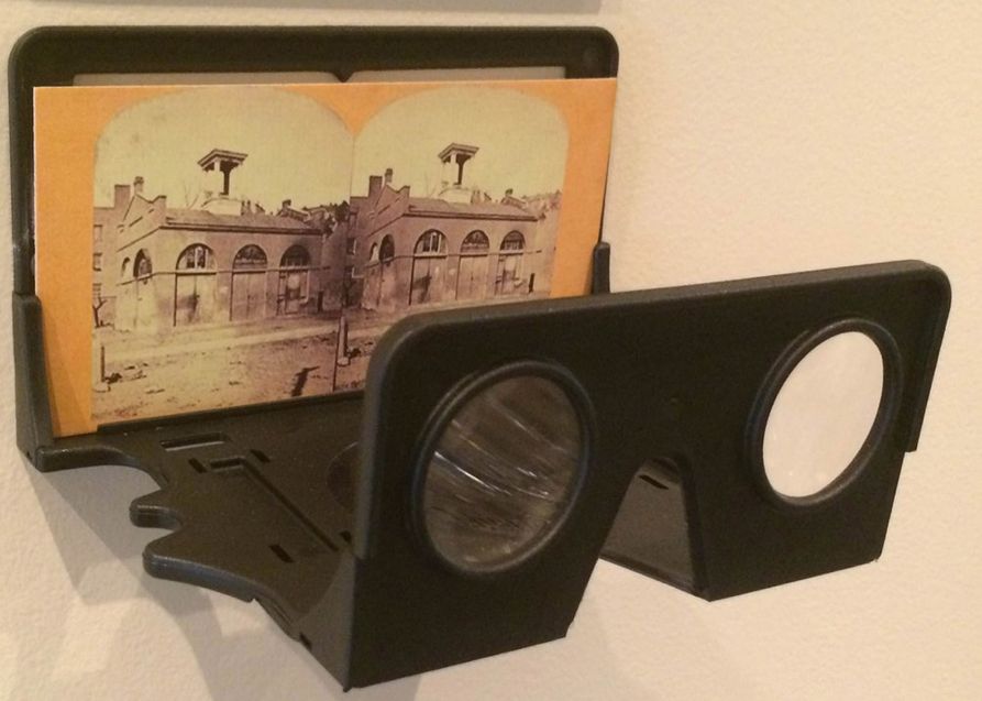 An image of John Brown's fort displayed as a stereoscope image in front of a double eyed lens for viewing 