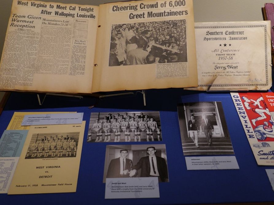 A scrapbook including newspaper clippings, team photographs, and other documents concerning Jerry West's life and career