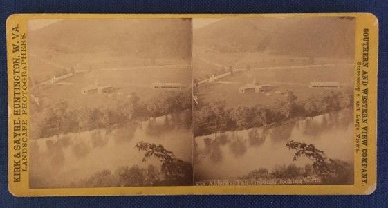 Stereograph slide of a river, running through open fields and hills