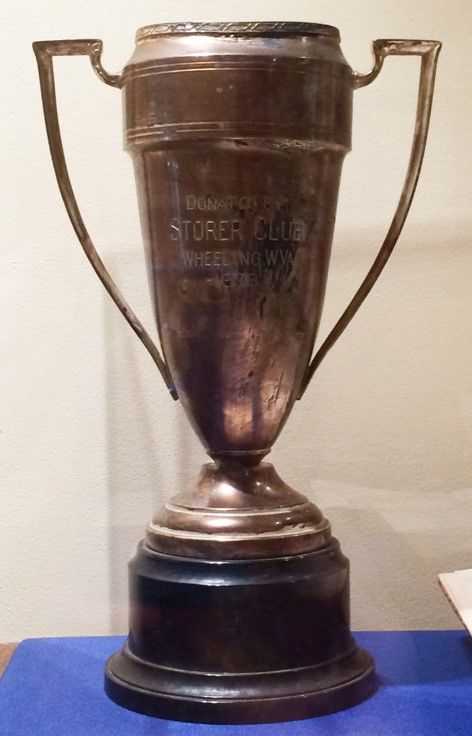 A large, bronze cup trophy on a black base.