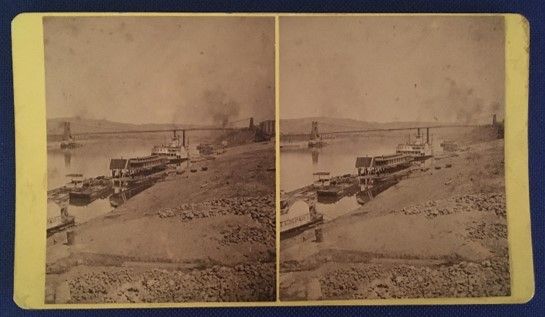 Stereograph slide of a river and industrial wharf. 