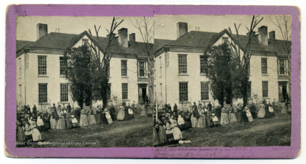 A stereograph image of a large white building with a crowd of people in front. The same image is repeated side by side.