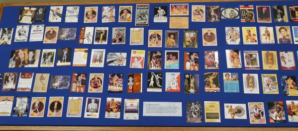 A large display of several vintage Jerry West basketball cards from over the years. 