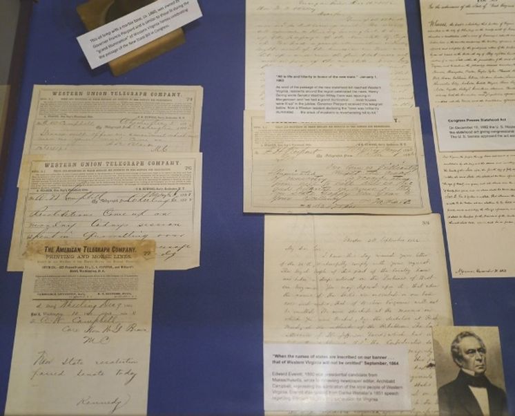 Selection of documents concerning the celebration of WV statehood on a blue background