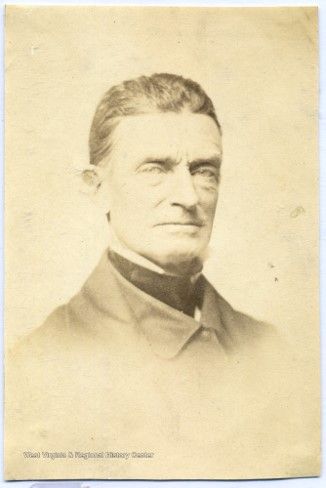 A cabinet card of a white middle-aged man with a high-necked shirt, necktie, and jacket. This is John Brown. 