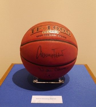 A basketball displayed on a blue pedestal