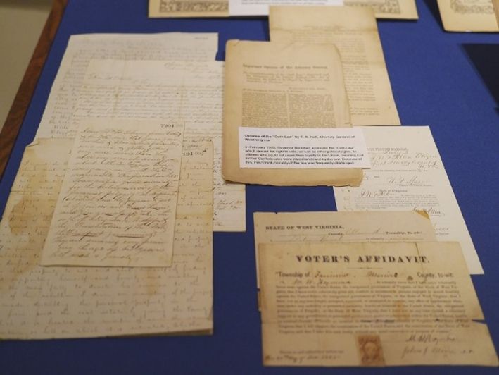 Documents concerning oaths of allegiance in post-war West Virginia, displayed on a blue background 