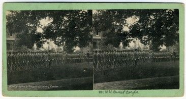 A stereograph slide of the outdoors where several people stand in a row