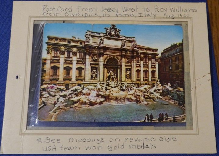 an image of a building with roman architecture. The top reads "Postcard from jerry west to roy williams from olympics in rome, itally Aug 1960." The bottom says "see message on reverse side. USA team won gold medals"