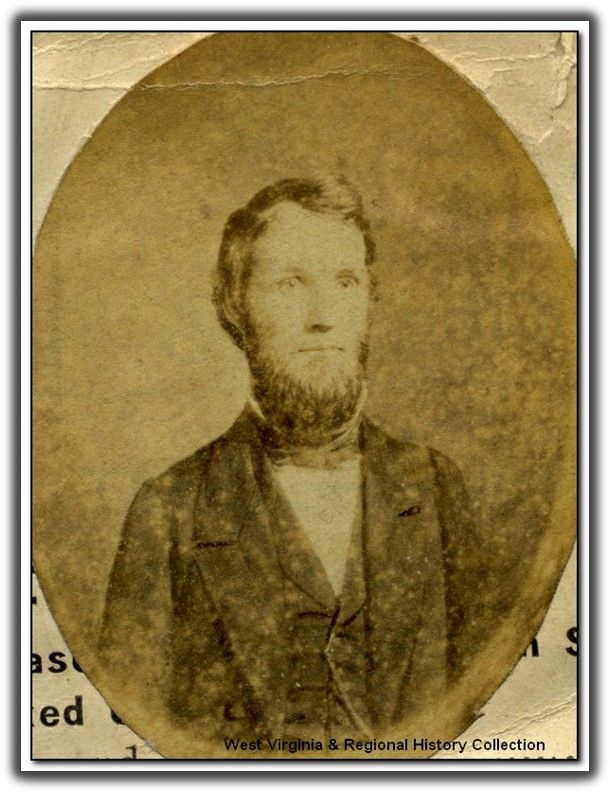a white man with short beard and a high collared shirt with a jacket and vest 