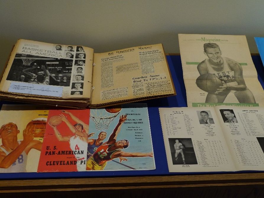 Several documents, including a scrapbook and photos of Jerry West as various points throughout his life 