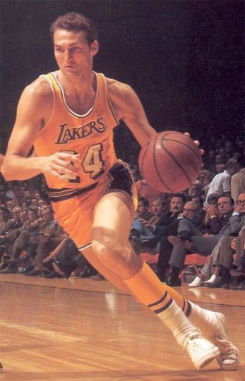 jerry west on the court, running and holding a ball. it almost exactly resembles the player sillohuette on the logo