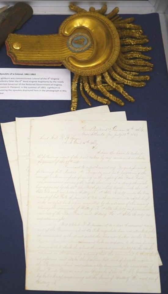 Documents relating to Joseph A.J. Lightburn's military career displayed on a blue background