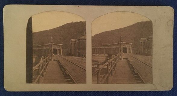 Stereograph of railroad tracks leading into tunnel.