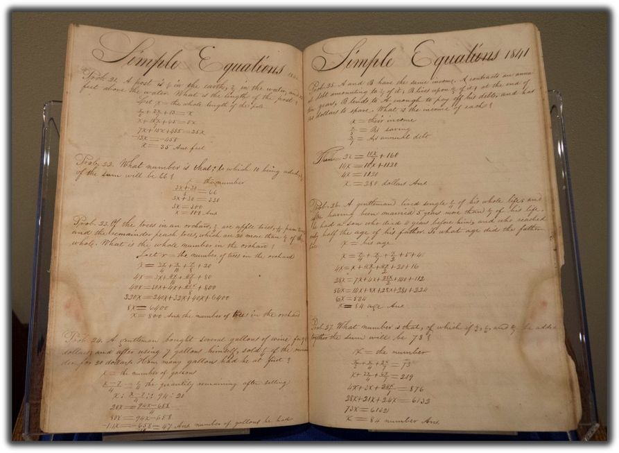 an open math workbook, with neat cursive and organized straight lines